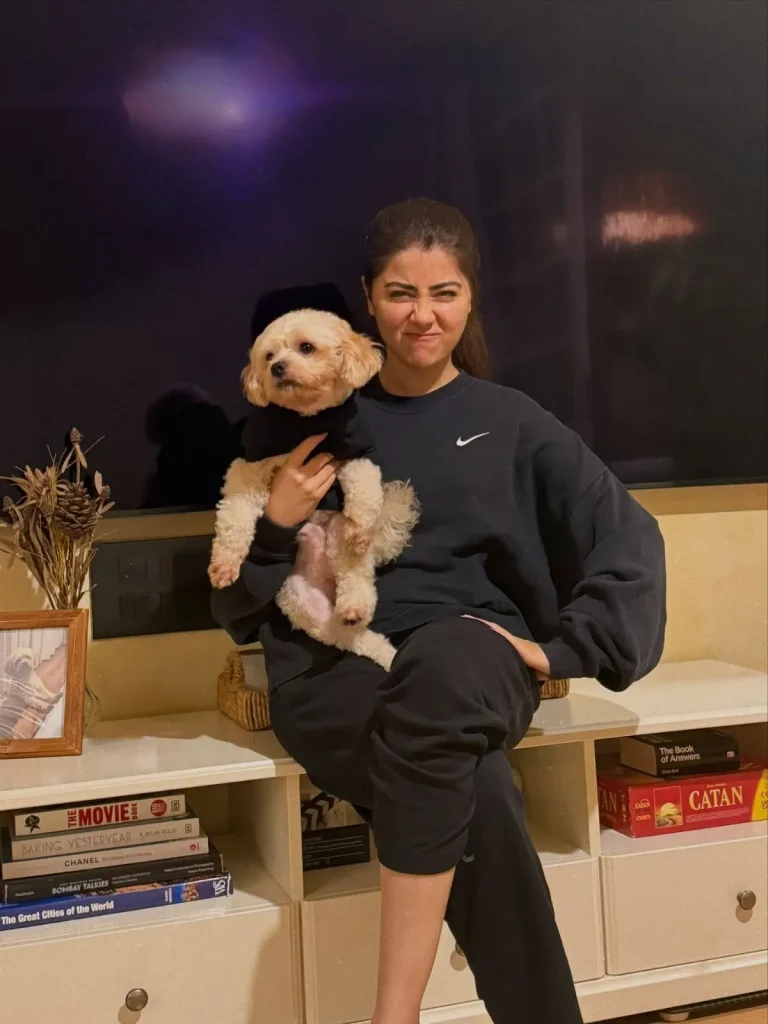 A person sitting near a foster dog in a living room, reflecting on the challenges of fostering.