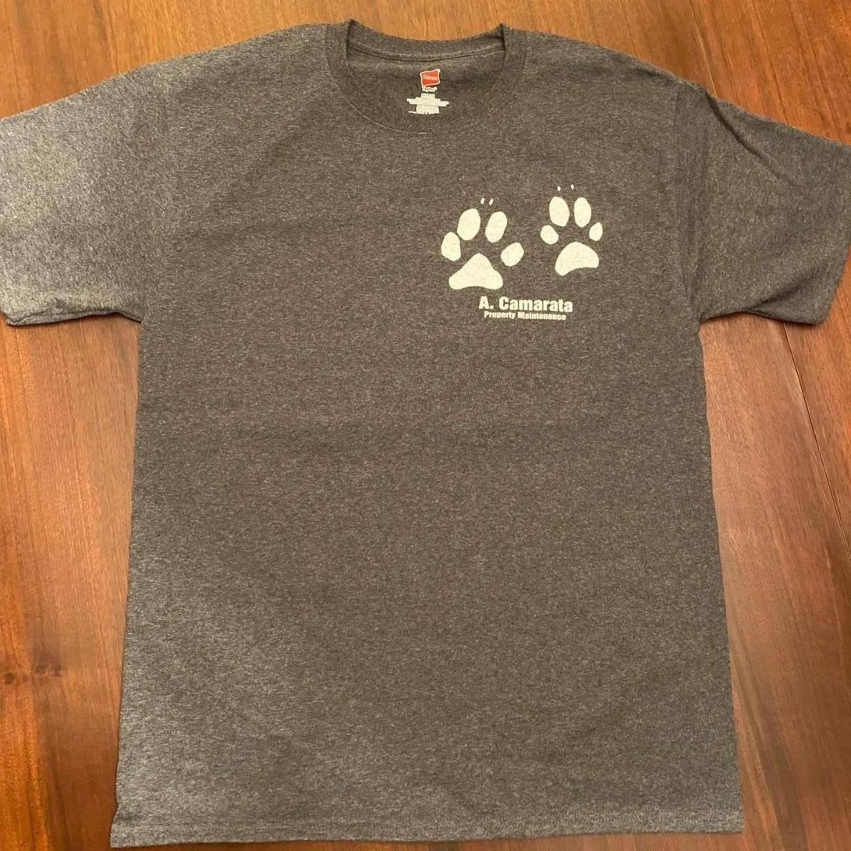 A volunteer shirt marked with a muddy paw print from a shelter dog