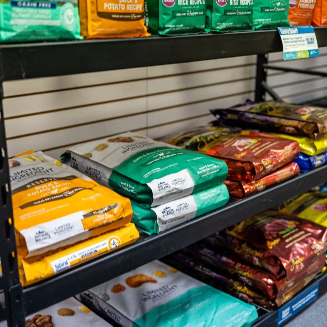 Organizing animal shelter food pantry donations Organized shelves of pet food donations in a shelter pantry