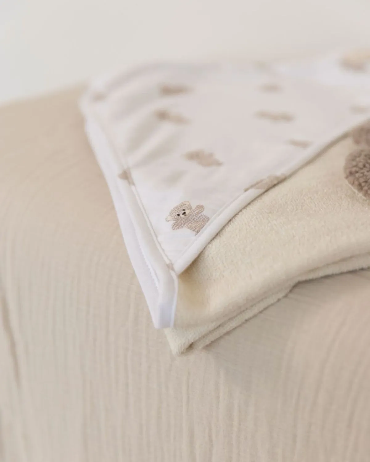 Securing Foster Kitten Body Safely A clean, folded fleece blanket on a vet table representing safe and respectful aftercare for a foster kitten.
